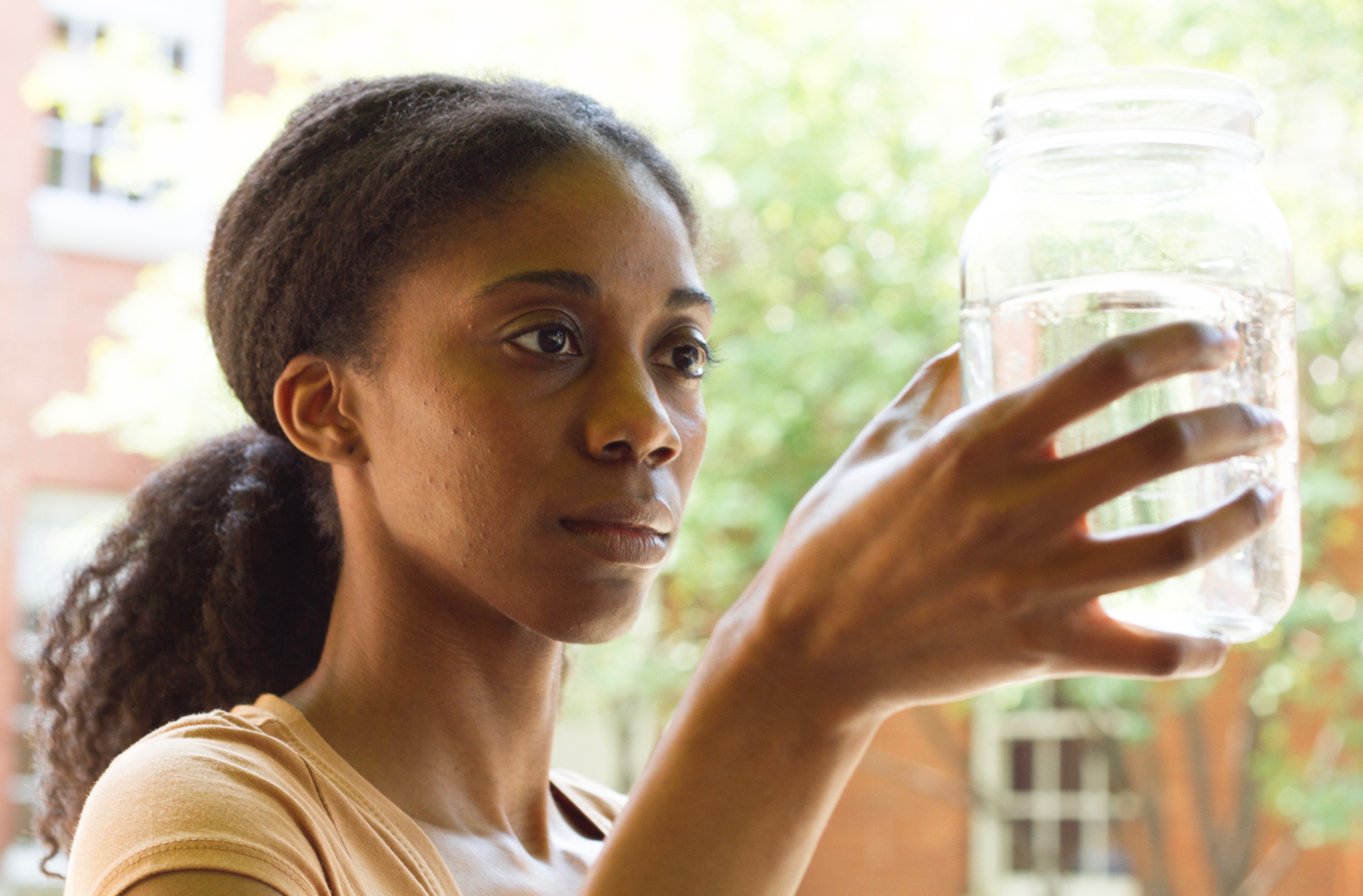 The glass is more than half full, but of what? Sierra (Siovhan Christensen) contemplates the effects of fracking in "Driftless."