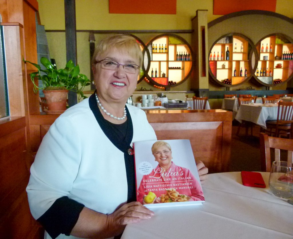 Lidia proudly shows her latest cookbook, 'Celebrate Like an Italian.'