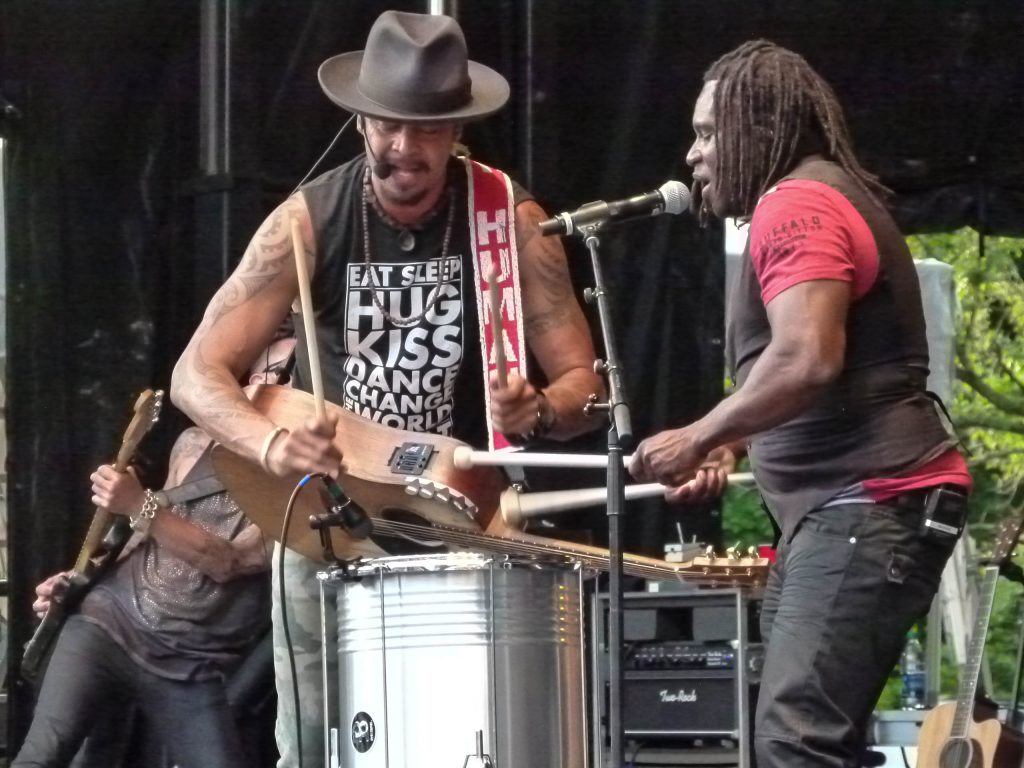 Drummer Manas Itiene teams up with Franti on an upright drum.