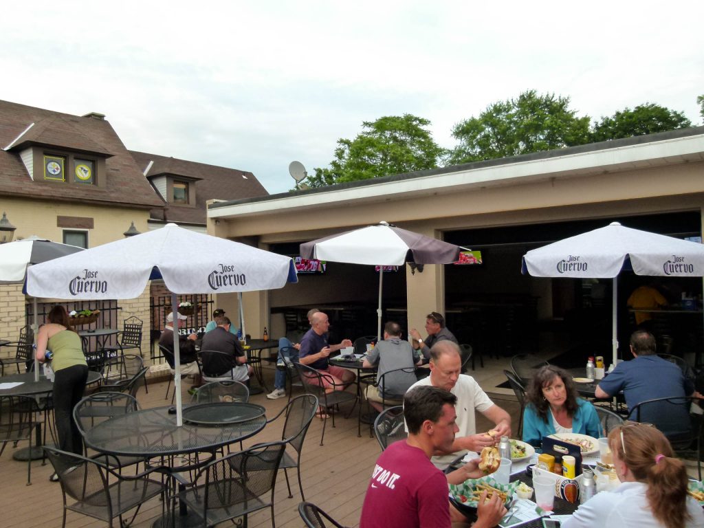 Diners enjoying an evening meal on the second floor patio deck of the Oakmont Tavern.