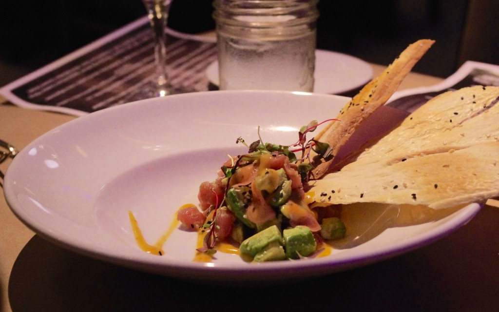 Tuna tartare with avocado, preserved radish and harissa orange mignonette, served with crunchy, peppery crackers.