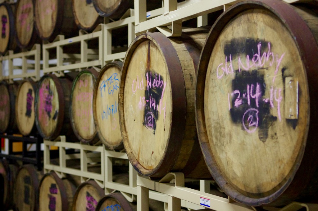 Behind the scenes in the brewery, beer stacked in barrels.