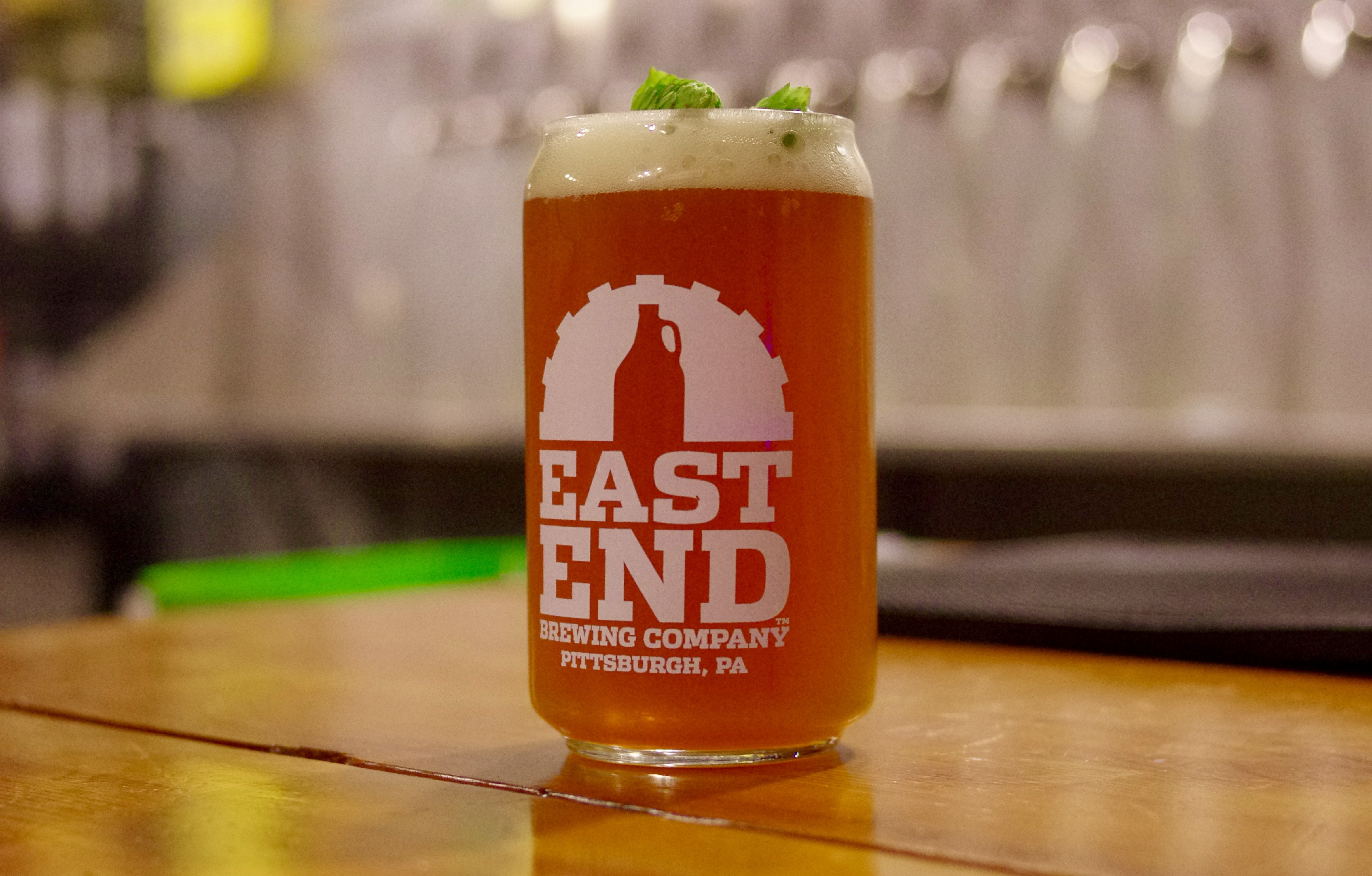 Two fresh hop buds garnish a glass of Big Hop Harvest Ale, which is made with wet hops, instead of dried.