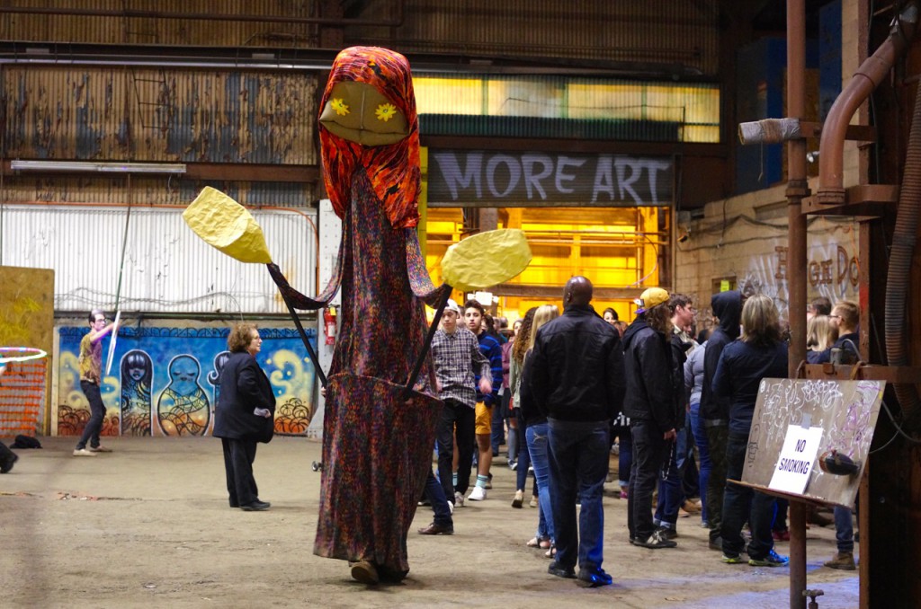 A stilt performer entertains crowds at Art All Night.