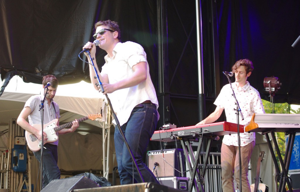 Vocalist Matt Bishop leans into the microphone on stage with Hey Marseilles.