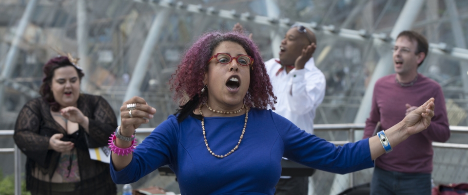 Performance artist Christiane D leads the Complaints n'at Choir at Gateway Center’s “T” Station in downtown Pittsburgh.