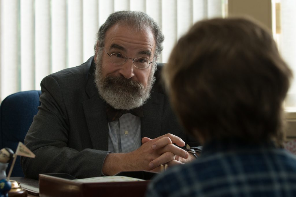 Mr. Tushman (Mandy Patinkin) listens and offers support to Auggie.