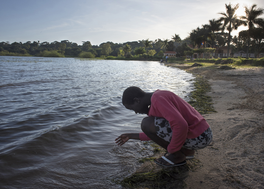 Rial's photos capture visions of hope: Jalia, a girl from the Bright Kids Uganda orphanage, contemplates the waters on an outing to Lake Victoria. She lost both parents to AIDS and her goal is to be a surgeon.