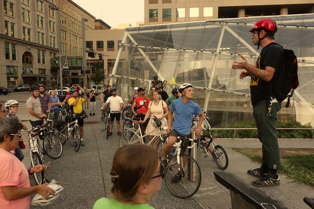 Cyclists listen to a talk during last year's Future of Downtown Bike Infrastructure Ride in downtown Pittsburgh.