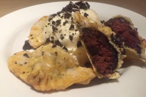 Braddock's Pittsburgh Brasserie featured February Pierogie is filled with red velvet cheesecake and topped with an Oreo cookie crumble and cream cheese drizzle.