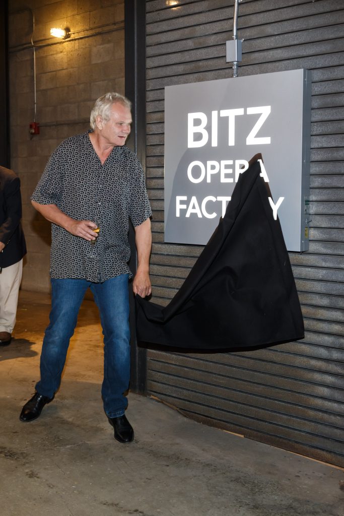 Francois Bitz pulls down the draping to joyfully see the Pittsburgh Opera headquarters renamed in his honor. (Photo: David Bachman)