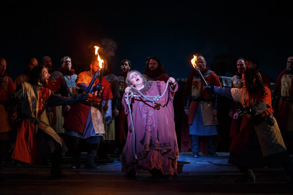 Captured to burn in a blazing pyre, Azucena (Marianne Cornetti) bemoans her fate while secretly plotting to save her son Manrico. Cornetti’s performance sets the Benedum stage on fire.