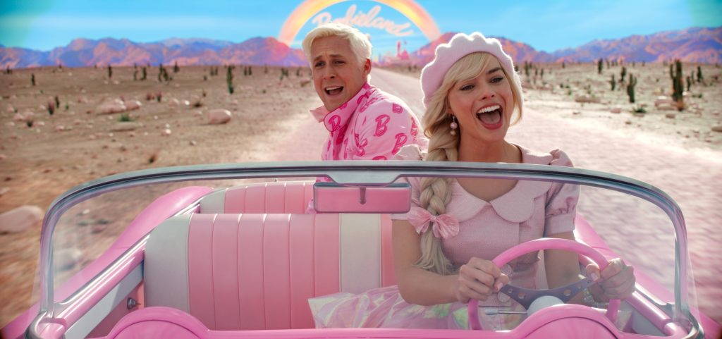 Barbie (Margot Robbie) and Ken (Ryan Gosling) singing together on a long road trip. (Photo: Copyright Warner Bros. Entertainment.)
