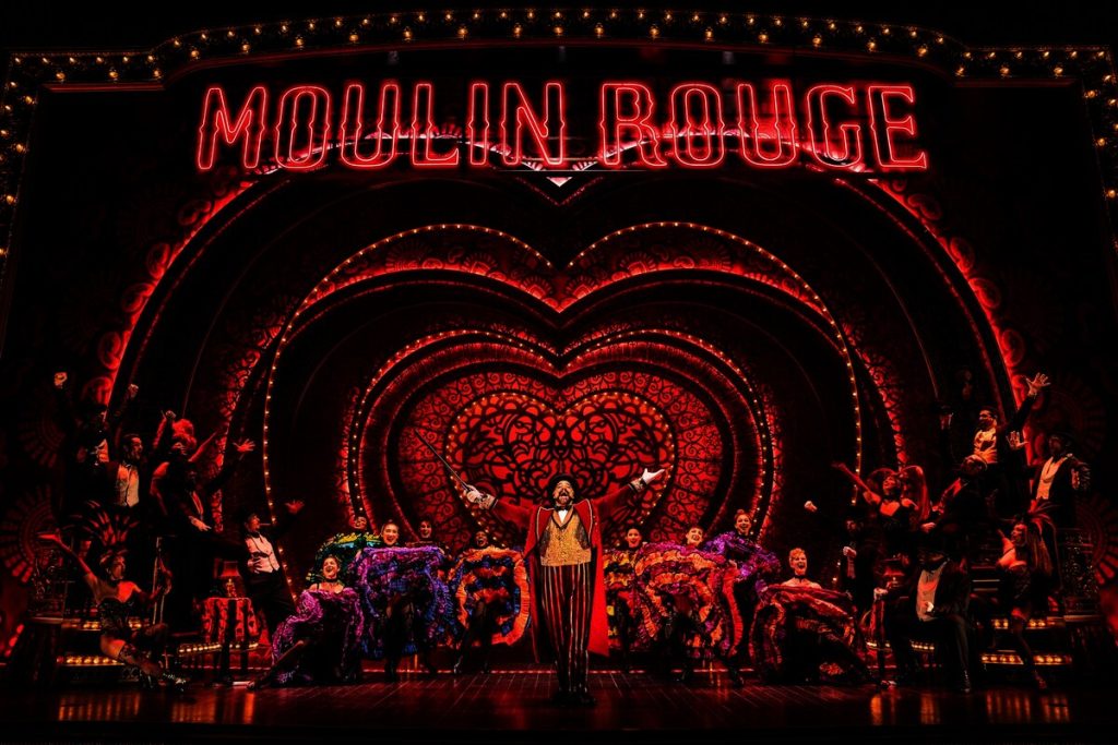 Harold Zidler (Robert Petkoff), the master of all masters of ceremonies, welcomes his “chickens” to the Moulin Rouge.