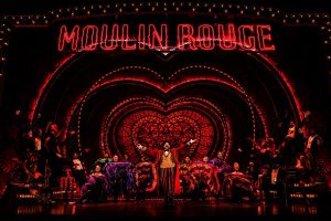 Harold Zidler (Robert Petkoff), the master of all masters of ceremonies, welcomes his “chickens” to the Moulin Rouge.