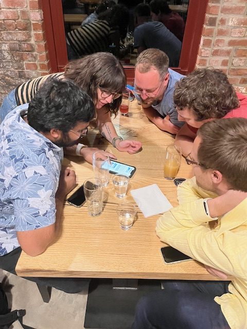 Beer drinkers huddle up during a game of team trivia. (Photo: C. Prentiss Orr)