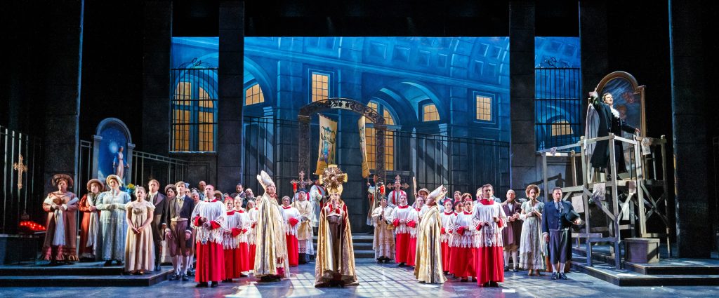 Pittsburgh Opera’s production of Tosca offers a stunning tableau of dramatic contrasts. As Sant’Andrea’s Te Deum devoutly begins, Baron Scarpia (on scaffold) unleashes his vile scheme.