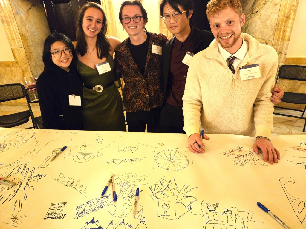 Enthusiastic CMU architectural students man the future of Pittsburgh mural table.