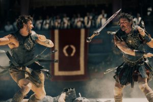 Some hot action as gladiators battle and swords are flying. Paul Mescal plays Lucius and Pedro Pascal plays Marcus Acacius.