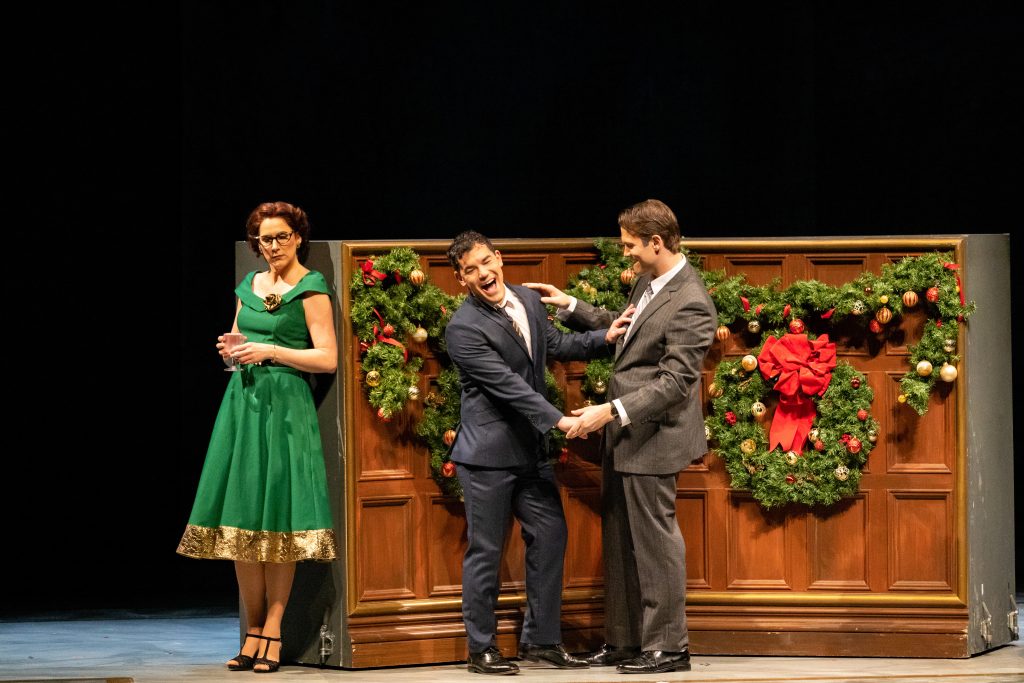 It’s Christmas in Washington, DC. Tim, a congressional aide laughs it up with a State Department 'friend,' while Mary overhears their amorous antics. (Photo by David Pearson for Virginia Opera.)