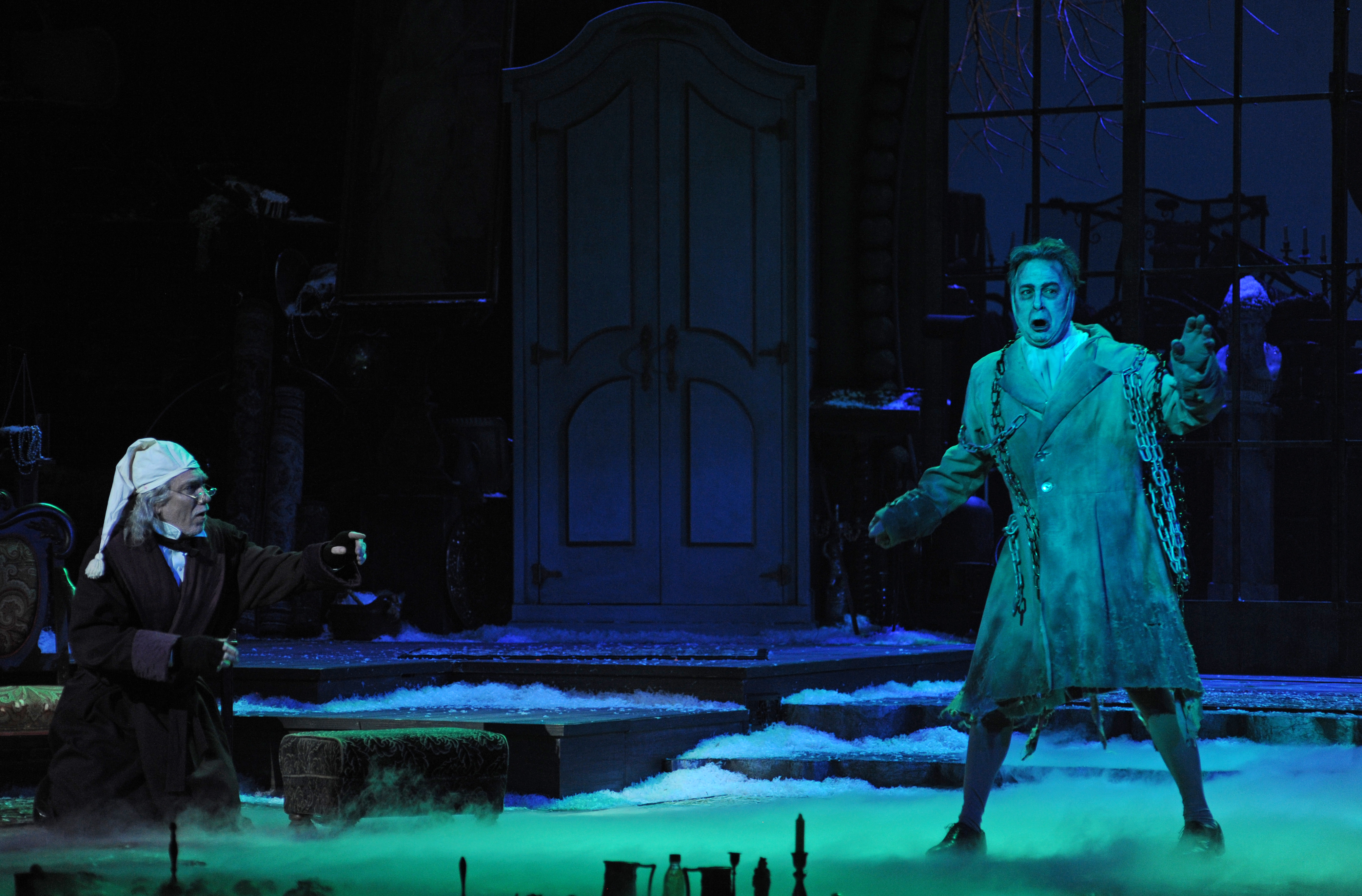 Scrooge (Patrick Page) is visited by a ghost of Christmas (Daniel Krell). Photo: Archie Carpenter.