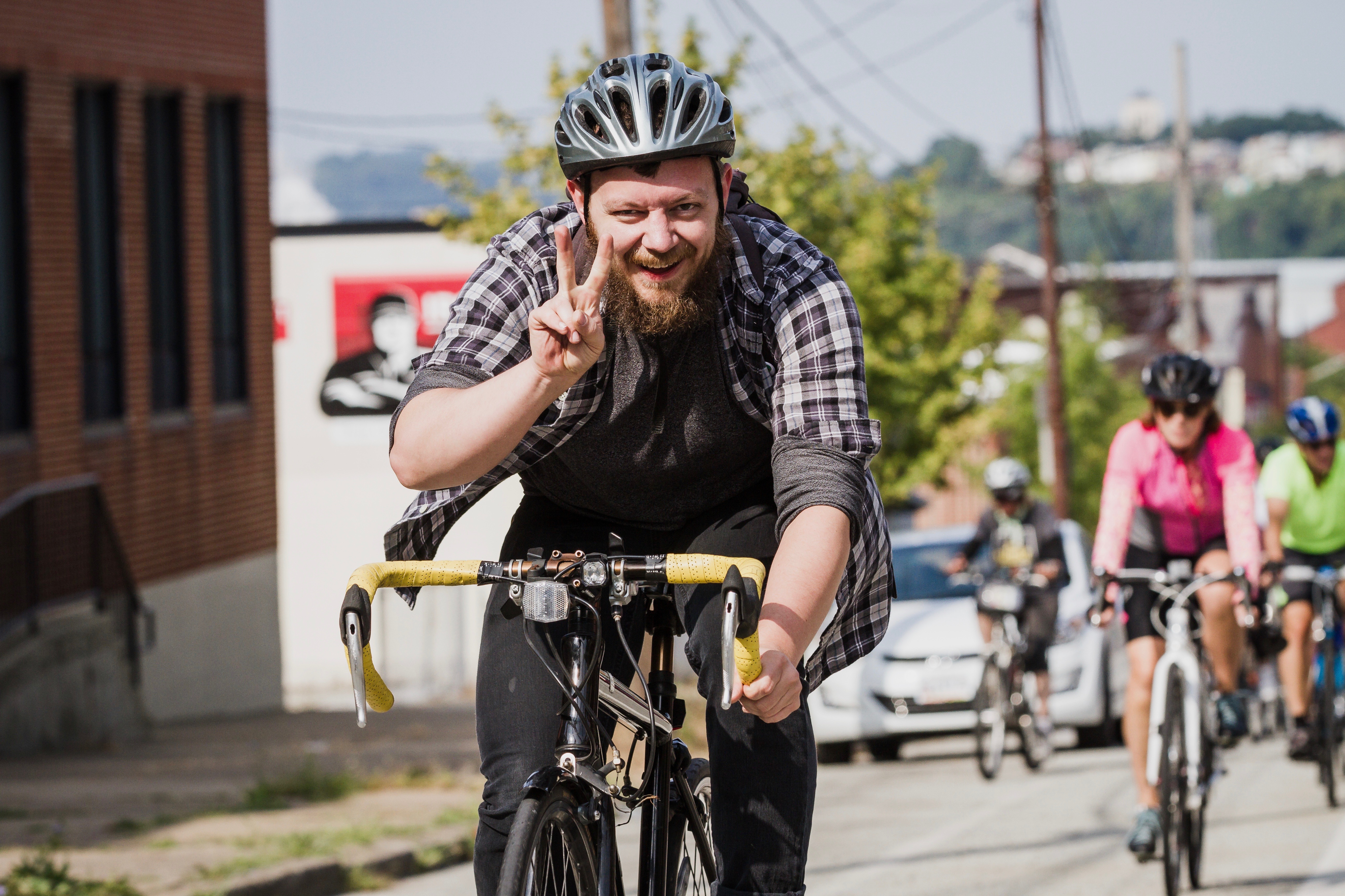 As this gentleman illustrated, the 'peace' sign is a good sign to observe when cycling. (photo courtesy of BikePGH)
