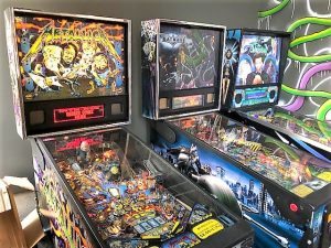 Three pinball machines—Metallica, Batman, and the Shadow—stand ready for flipper fingers.