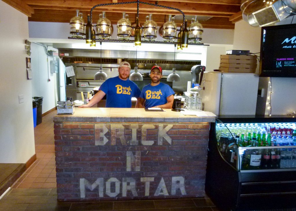 Head Chef Jon Tryc (L.) and owner Ricci Minella (R.) enjoy creating delicious food and interacting with customers.