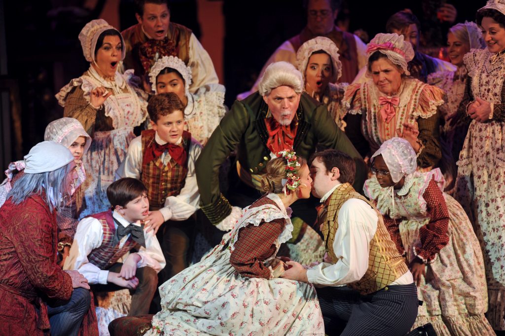 Tim Hartman, as Mr. Fezziwig, scrupulously supervises the kissing kiddies in Pittsburgh CLO's 'A Musical Christmas Carol.' The scene is from last year's production but Hartman, and the play, return this month. (photo: Matt Polk)
