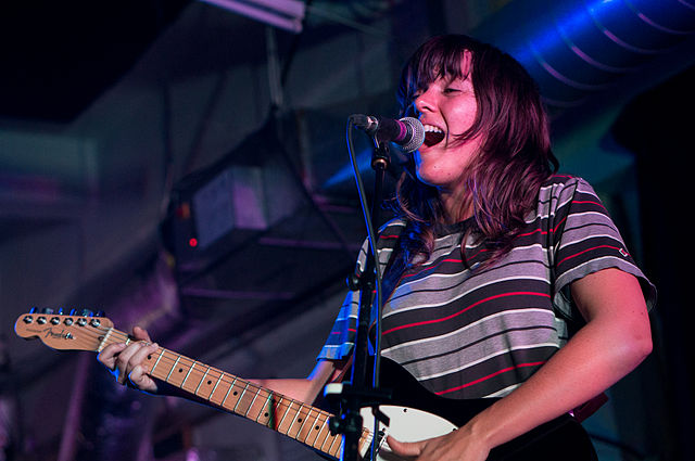 Courtney Barnett performing at a concert in 2015. (photo: Paul Hudson and Wikipedia)