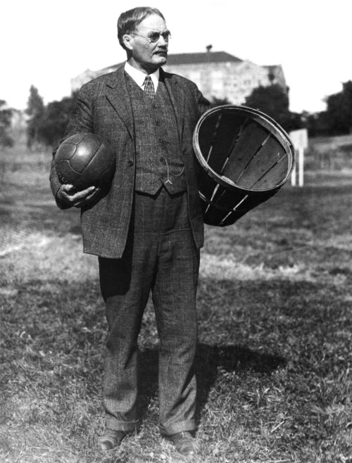James Naismith with an early basketball (actually, a soccer ball) and a basket (literally) into which it should be shot.