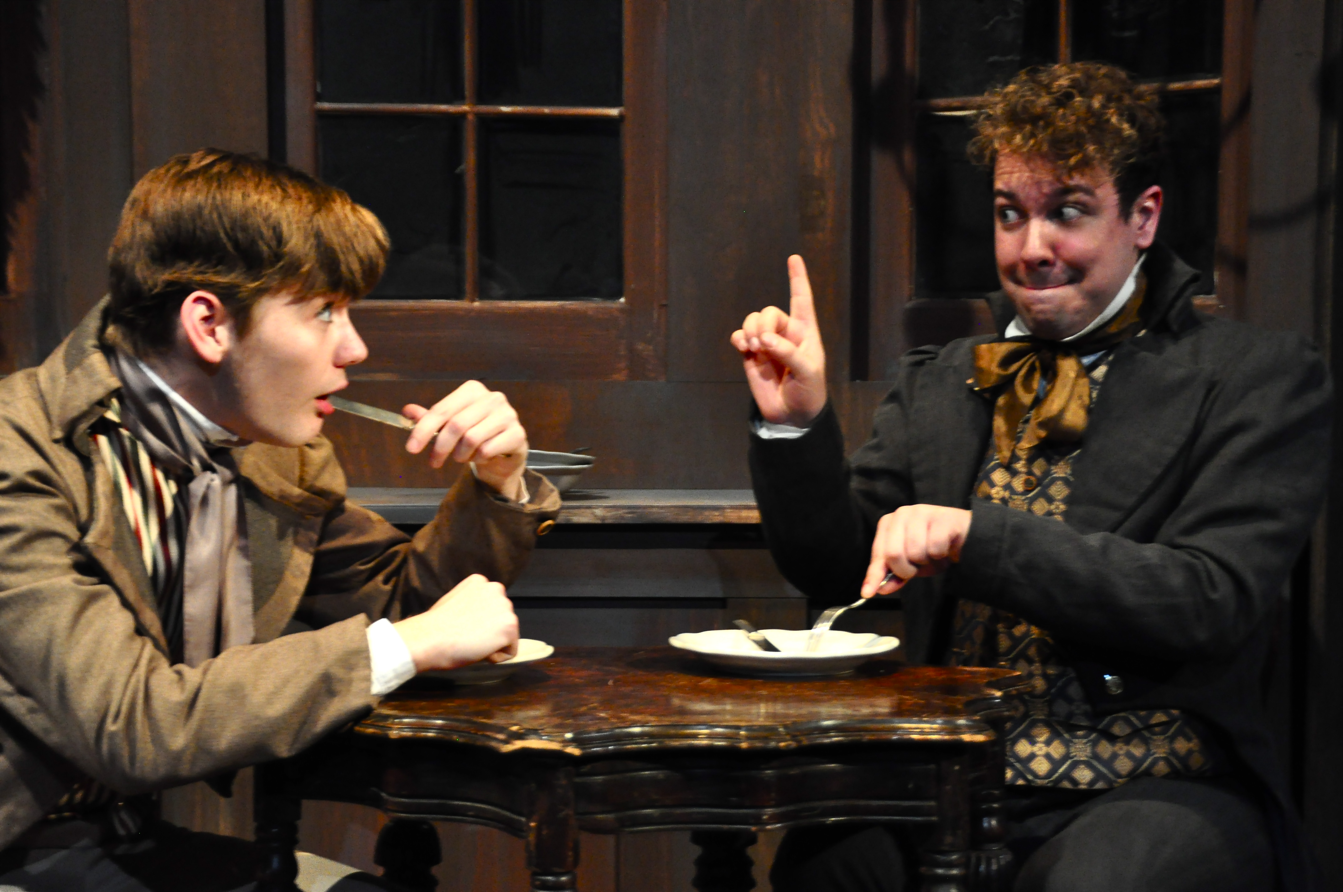 In PICT's "Great Expectations," young Pip (Dylan Marquis Meyers, L) learns gentlemanly table manners from Herbert Pocket (Jordan Ross Weinhold). Photo: Suellen Fitzsimmons.