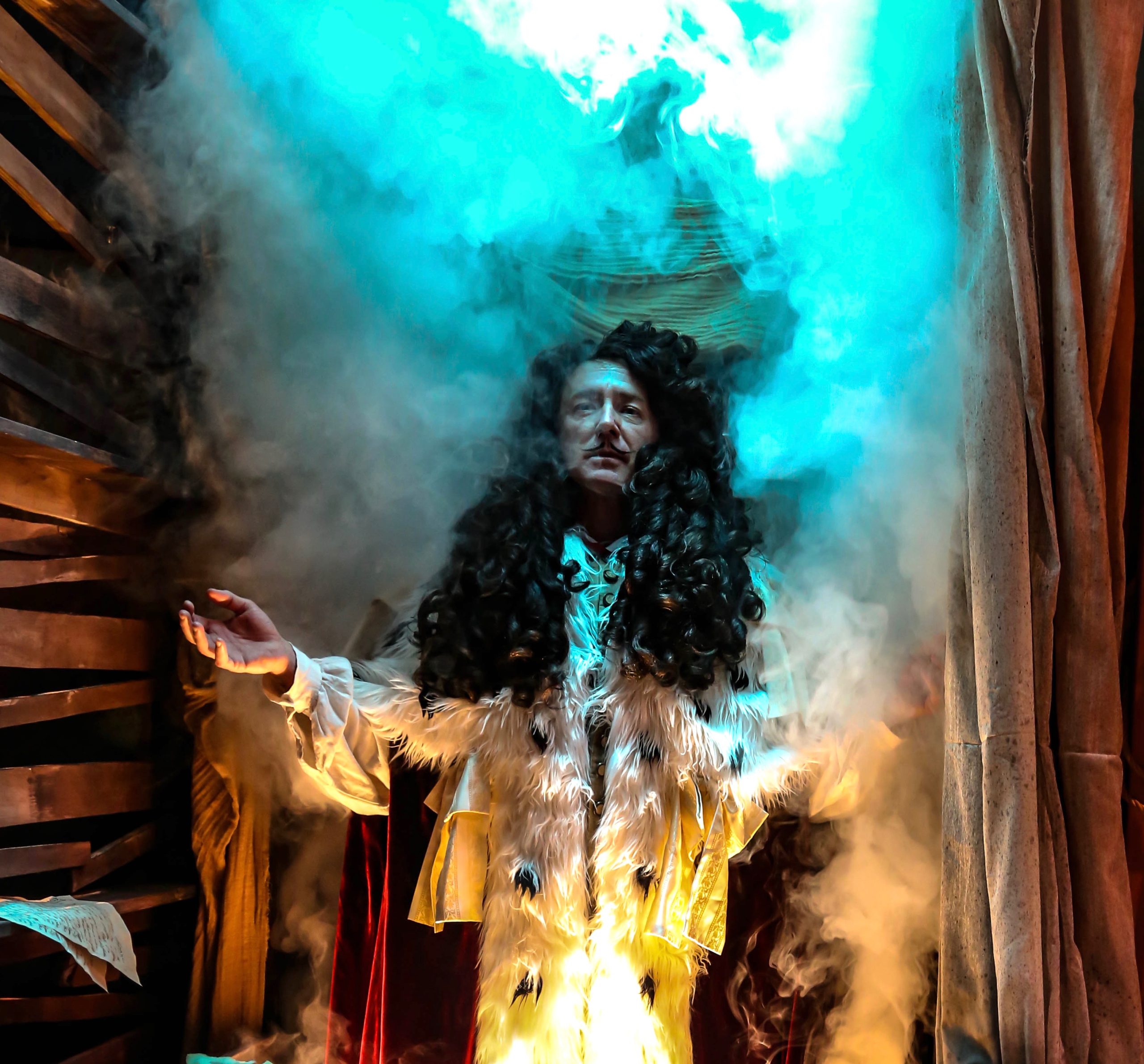 Wait for it. Amid mayhem, his solar majesty Louis XIV materializes. Under the big wig is actor David Whalen.