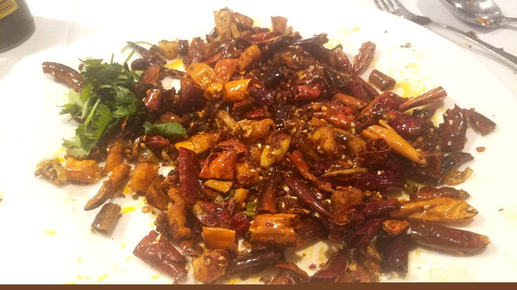 Remaining chili peppers and Szechuan peppercorns from Chongqing style chicken dish.