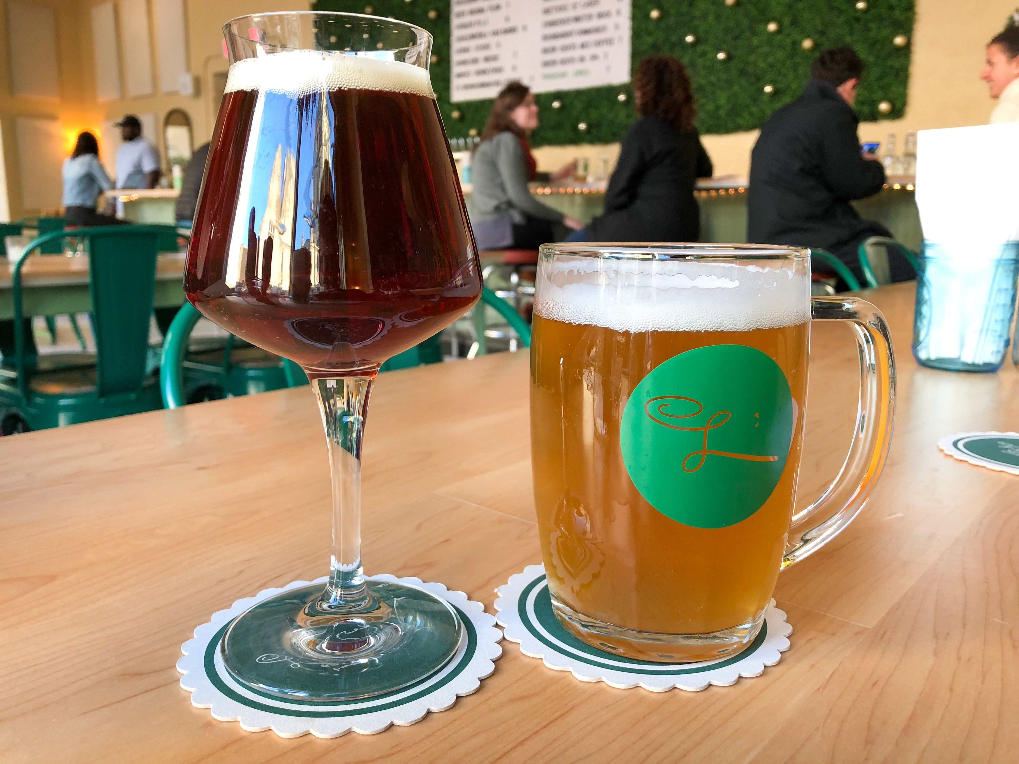 The long-stemmed tulip glass has a pour of Einbecker Winter-Bock, a German doppelbock. In the stein is the Únětické Pivo 12°, a Czech lager. Notice East Liberty Presbyterian Church reflected on the tulip glass.