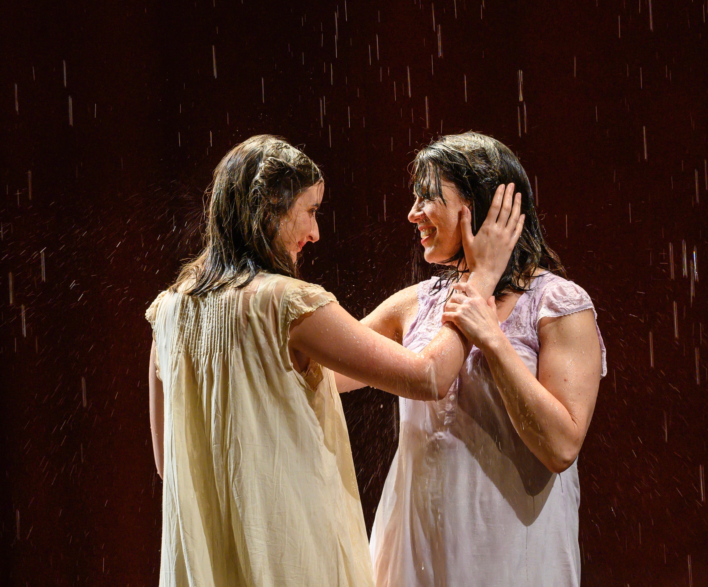 Rifkele and Manke (Emily Daly, L, and Meg Pryor) baptize their love in a spring shower.