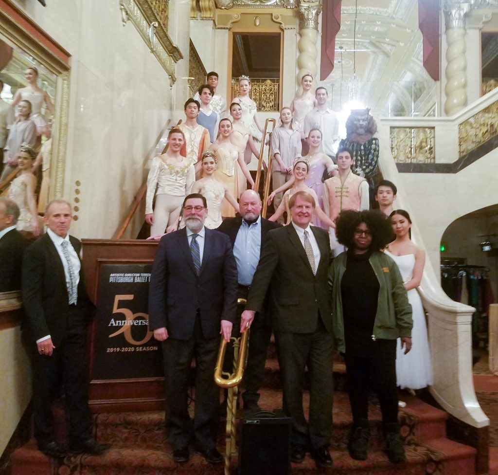 PBT Artistic Director Terrence S. Orr, center is flanked on the left by Pittsburgh Mayor Bill Peduto and PBT Executive Director Harris N. Ferris; and on the right by Allegheny County Executive Rich Fitzgerald and Artist in Residence Staycee Pearl. PBT dancers are behind them.