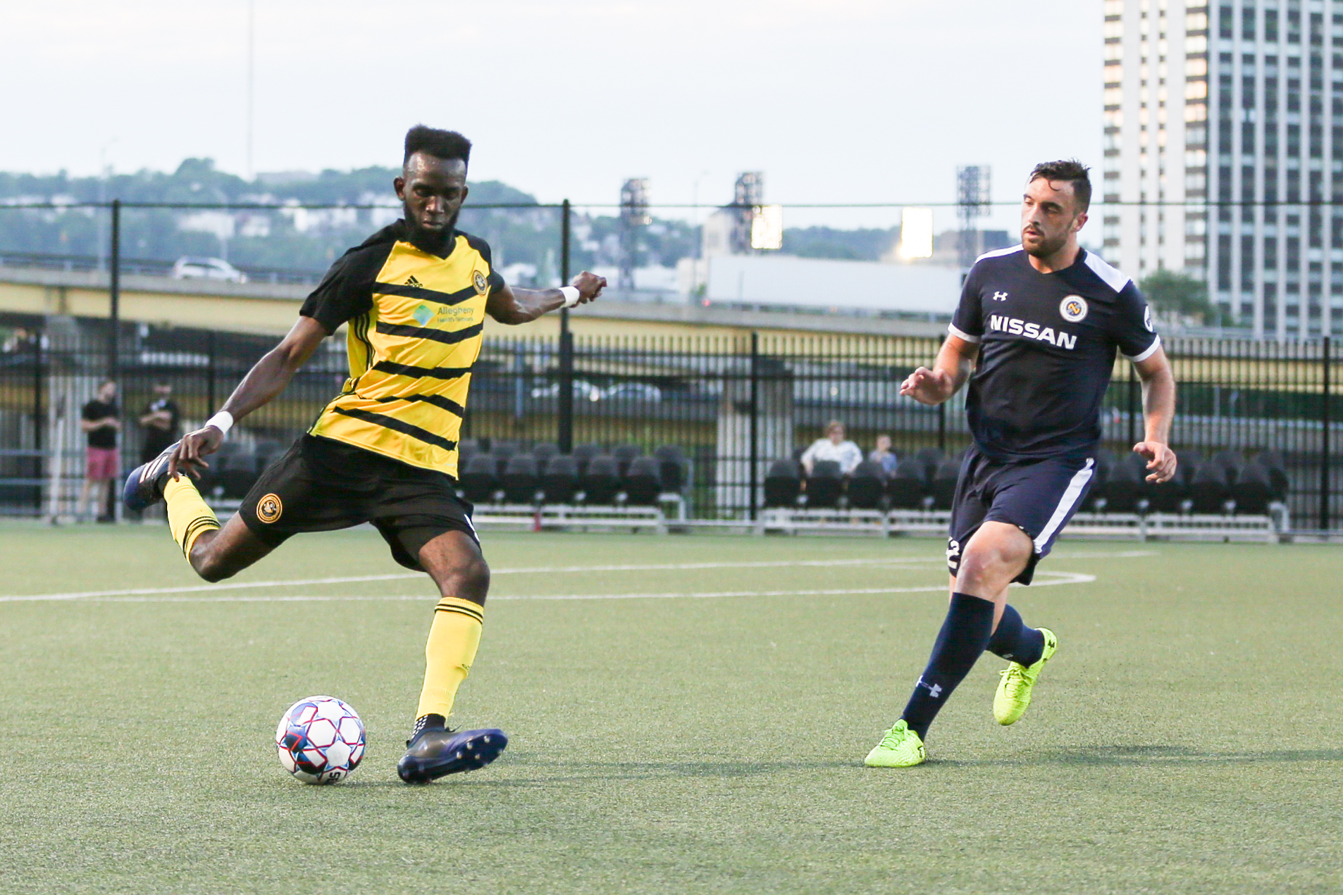 A Riverhounds forward takes a shot on goal as a defender closes fast. Photo: Chris Cowger.