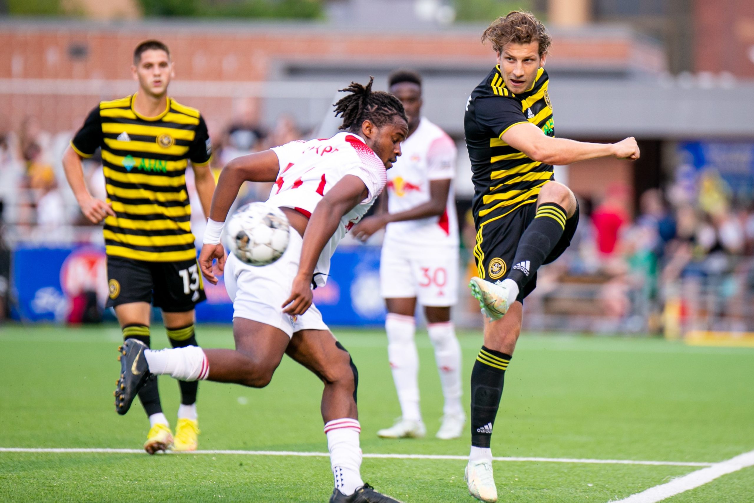 Russell Cicerone kicks the ball past a New York Red Bulls II defender. (Photo: Chris Cowger/Riverhounds SC)