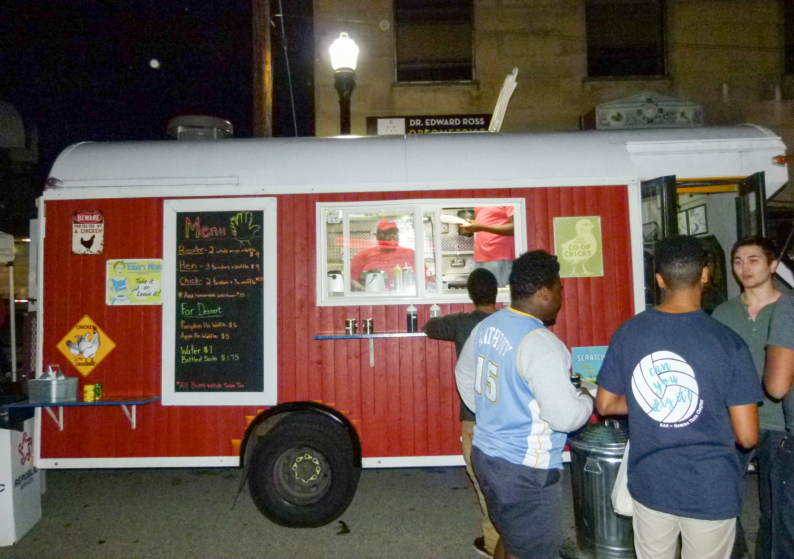 The Coop Chicken and Waffles food truck on the scene. Earsell Fitzgerald (in window) prepares food for a customer while his brother Justin (standing in the truck) restocks. Also working in the truck is Nikki.