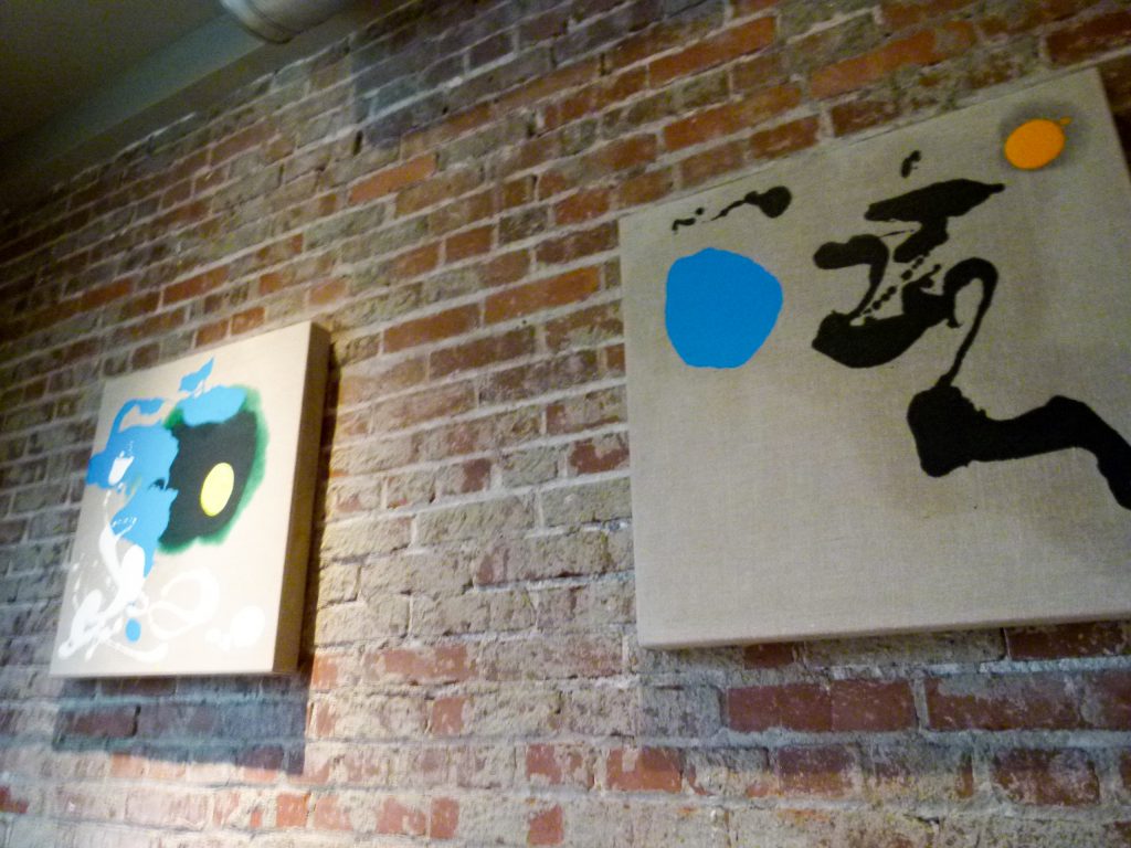 Paintings by Pittsburgh artist Mia Tarducci adorn the walls of the smaller second dining room.