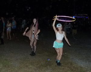 Kayla Kklcik displays her hula hoop talents while her friend Gabby McRoberts dances nearby.
