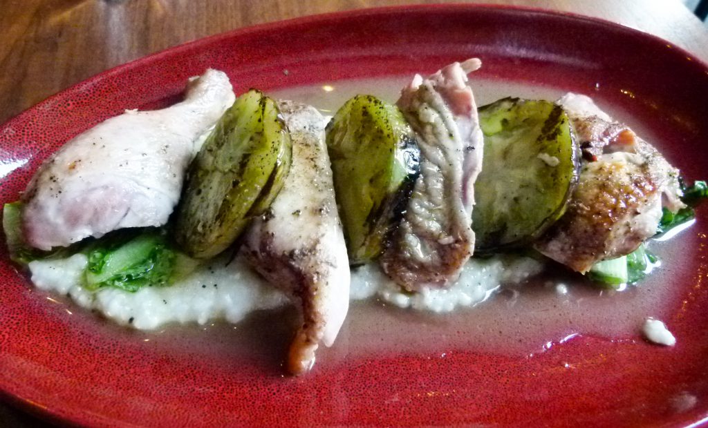 Wood roasted Gerber Farms chicken with grilled green tomatoes and polenta.