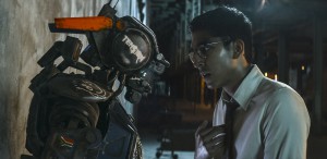 Deon (Dev Patel) boots up Chappie with the new program.