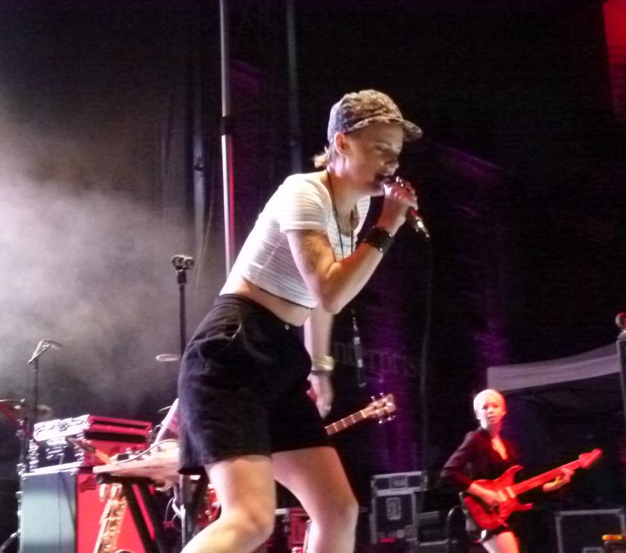 Rubblebucket's lead singer and saxophonist Annakalmia Traver performing near the front of the stage.